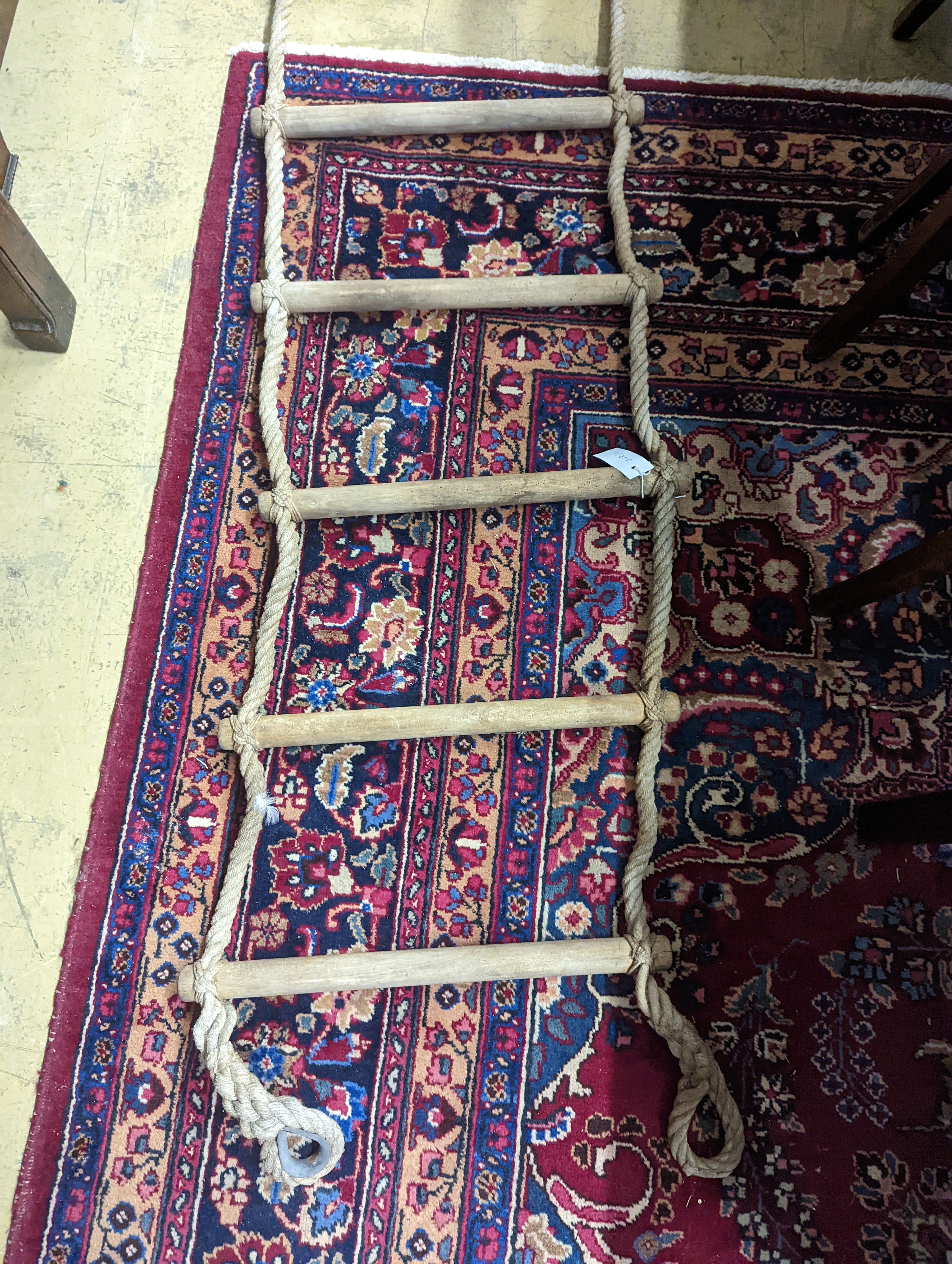 A rope ladder, Length 3.9 meters. (1 lower rung damaged)